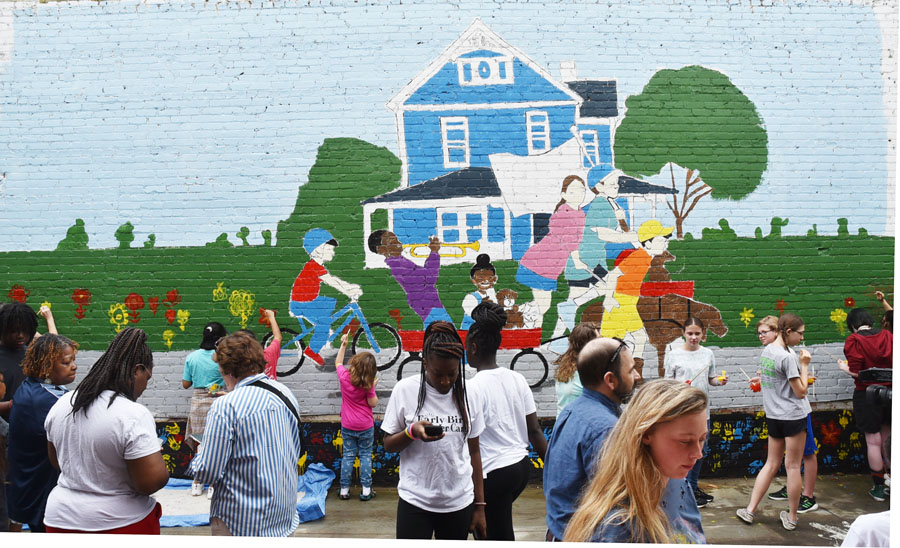 Residents Turn Out To Help Paint ‘Children On Parade’ Mural